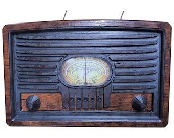 May include: Vintage-style radio with a dark wood frame and a dark gray speaker grill. The radio features a yellowed dial with a needle and station indicators. Two knobs and a series of buttons are visible on the lower section.