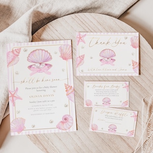 May include: A set of baby shower stationery with a seashell theme. The invitation, thank you card, and other cards feature pink seashells, pearls, and starfish. The invitation reads "shell be here soon" and includes event details.