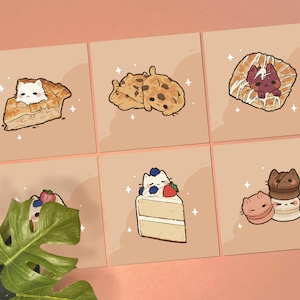May include: Six square cards featuring illustrations of cats integrated with desserts: a white cat in a pie slice, two cats as chocolate chip cookies, a cat in a pastry, a cat with berries on cake, and stacked cat-shaped macarons on a tan background.