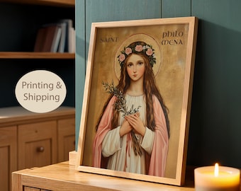 May include: A framed wall art print featuring a portrait of Saint Philomena with long brown hair, a pink rose crown, and a white and pink robe. The figure holds a green palm branch against a gold background. The text SAINT PHILOMENA is visible.