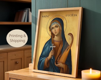 May include: A framed print featuring an icon of Saint Cecilia against a gold background. The figure wears a blue head covering and robe over a brown garment, holding a small silver cross and a wooden harp. The text SAINT CECILIA is visible.