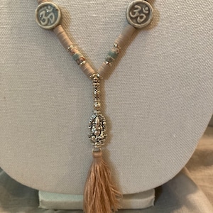 Ganesh pendant with ceramic OM beads, speckled moss jasper stones, beige and ivory clay heishi beaded necklace with tassel
