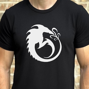 May include: A black t-shirt with a white graphic of a stylized dragon curled into a circle.