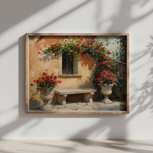May include: A framed print depicting a courtyard scene with a stone bench, window, and two urns overflowing with red roses. The wall is painted in warm tones, and the scene is framed by a wooden border.