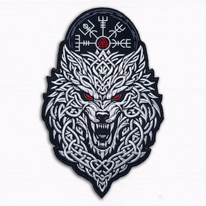 May include: Embroidered patch showing a white wolf head with red eyes and detailed knotwork. A black oval shape at the top features Viking symbols. The patch has a black border.