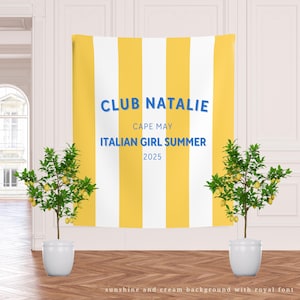 May include: A yellow and white striped backdrop with the text "CLUB NATALIE", "CAPE MAY", "ITALIAN GIRL SUMMER", and "2025". Two potted lemon trees are on either side of the backdrop.