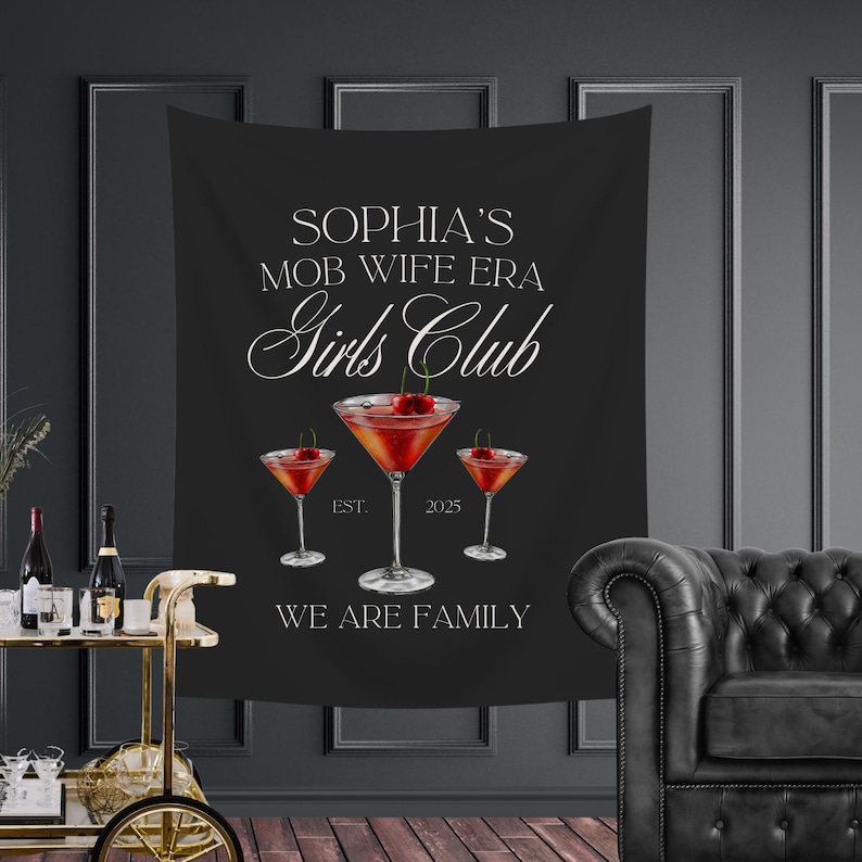 May include: Black tapestry with white text that reads "Sophia's Mob Wife Era Girls Club Est. 2025 We Are Family". Three martini glasses with cherries are depicted.