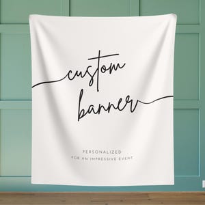 May include: White backdrop with black text that reads "custom banner" in a handwritten font. Below the text is "PERSONALIZED FOR AN IMPRESSIVE EVENT".
