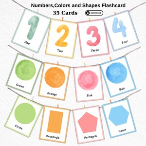 Op de afbeelding: Een set van 35 flashcards met nummers, kleuren en vormen. De kaarten zijn geïllustreerd met aquarel-achtige afbeeldingen en bevatten de woorden "Eén", "Twee", "Drie", "Vier", "Groen", "Oranje", "Roze", "Blauw", "Cirkel", "Rechthoek", "Vijfhoek" en "Hart".