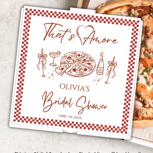 May include: A square white sign with a red checkered border featuring the text That's Amore, Olivia's Bridal Shower, and June 30, 2035. The design includes red line art illustrations of a pizza, a cocktail glass, a bottle, and two candles.