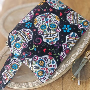 dia de los Muertos/sugar skulls wristlet bag with pocket inside to hold your ID card or keys.