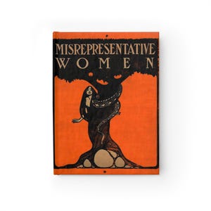 Peut inclure: Journal à couverture orange avec le titre "MISREPRESENTATIVE WOMEN" en noir. Une illustration noire d'une femme enlacée par un serpent dans un arbre est centrée sur la couverture. Le journal est de forme rectangulaire.