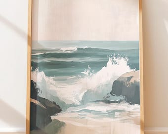 May include: A framed art print depicting a coastal scene. The artwork features a teal ocean with crashing white waves against dark gray rocks. The sky is a pale beige, and the frame is a light wood color. The print is displayed on a wooden floor.