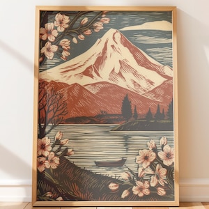 Puede incluir: Impresión artística enmarcada que representa un paisaje montañoso con un lago y flores de cerezo. La montaña tiene una cima nevada, y la obra de arte utiliza tonos de rojo, marrón y azul. Un pequeño bote flota en el agua.