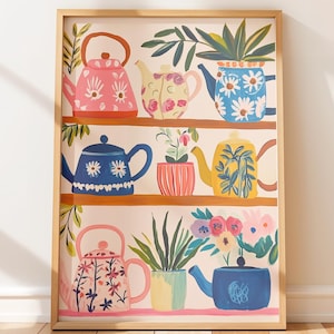 May include: A framed art print featuring a collection of colorful teapots and potted plants arranged on shelves. The teapots are painted in various colors, including pink, blue, and yellow, with floral and botanical designs. The artwork is set against a neutral background.