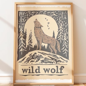 May include: Framed art print featuring a howling wolf silhouette against a full moon and forest background. The artwork is in shades of brown, black, and beige, with the words "wild wolf" at the bottom.