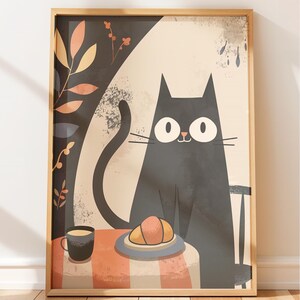 May include: A framed art print featuring a black cat with large eyes seated at a table. A croissant and coffee cup sit on the table with a striped tablecloth. The background includes floral elements and a neutral color palette.
