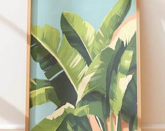 Op de afbeelding: Een ingelijste kunstdruk met grote, groene bananenbladeren met witte en perzikkleurige accenten tegen een lichtblauwe achtergrond. Het kunstwerk is ingesloten in een natuurlijke houten lijst, wat een tropisch thema creëert.