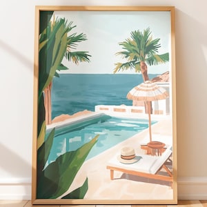 May include: A framed art print depicting a tropical scene. The artwork features a swimming pool, ocean, palm trees, and a beach umbrella. A lounge chair and a hat are also visible. The color palette includes shades of blue, green, and beige.