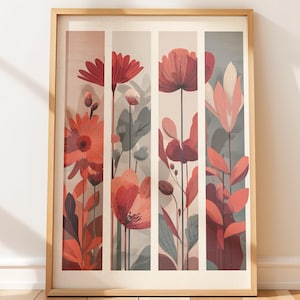 May include: A framed floral art print featuring stylized flowers in shades of red, coral, and pink. The artwork is divided into vertical panels with a neutral background, and the frame is a light wood color. The botanical illustration includes detailed petals and leaves.