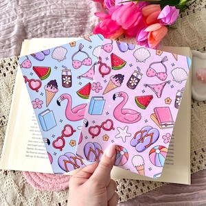 May include: Two illustrated cards with a summer theme. One is light blue, the other pink. Both feature repeating patterns of flamingos, ice cream cones, watermelon slices, and sunglasses. A bouquet of pink tulips is in the background.