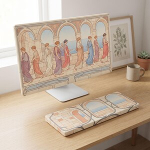 May include: A computer monitor and a matching keyboard wrist rest featuring a repeating illustration of figures in flowing robes walking along a stone colonnade overlooking the sea. The artwork uses a soft palette of peach, blue, and cream tones.