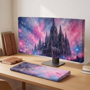 May include: A computer monitor and a matching keyboard wrist rest featuring a gothic cathedral design set against a vibrant pink and blue nebula sky. The artwork displays intricate spires and architectural details in a dark, moody style.