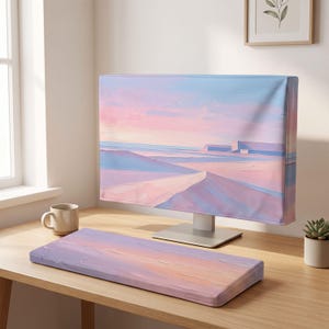 May include: A computer monitor cover and a matching rectangular keyboard wrist rest, both featuring an abstract landscape print in soft pastel shades of pink, blue, and lavender with visible brushstroke textures across the fabric surfaces.