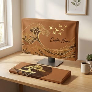 May include: A brown computer monitor cover featuring a gold wave pattern and flying cranes with the text Custom Name, paired with a matching rectangular keyboard wrist rest displaying a gold bonsai tree graphic on a dark circular background.