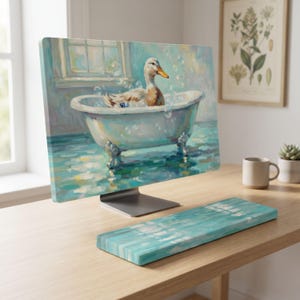 May include: A computer monitor and a matching keyboard wrist rest featuring an oil painting style illustration of a white duck sitting in a clawfoot bathtub filled with bubbles, set against a light blue wall with a window and soft lighting.