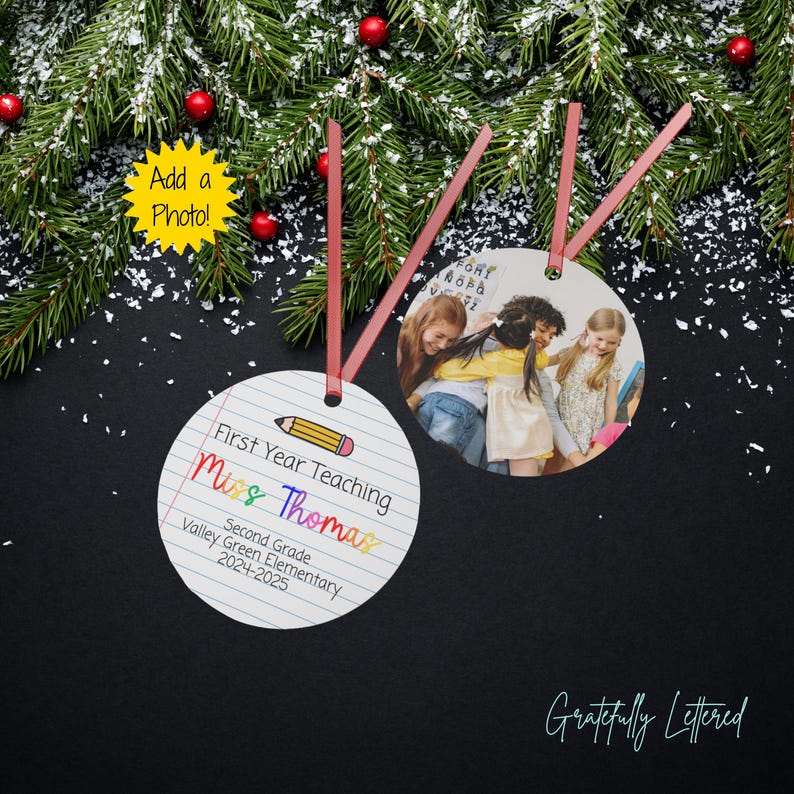 May include: Two round ornaments with red ribbon hangers. One ornament features a lined paper design with a pencil graphic and text reading First Year Teaching, Miss Thomas, Second Grade, Valley Green Elementary, 2024-2025. The other displays a photo.