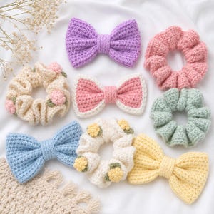 May include: A collection of handmade crochet hair accessories, including scrunchies and bow-shaped hair ties. The scrunchies are in pastel colors like pink, green, and cream, some adorned with floral details. The bows are in shades of purple, pink, and yellow.