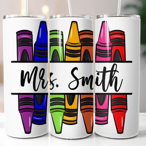 May include: Three white stainless steel tumblers with a design of colorful crayons and the text "Mrs. Smith".