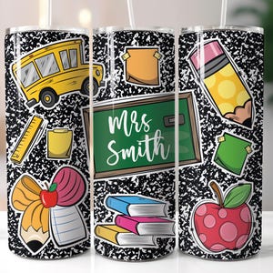 May include: A stainless steel tumbler featuring a black and white composition notebook paper design. The tumbler is decorated with school-themed stickers, including a yellow school bus, a green chalkboard with the name "Mrs. Smith", and a red apple.