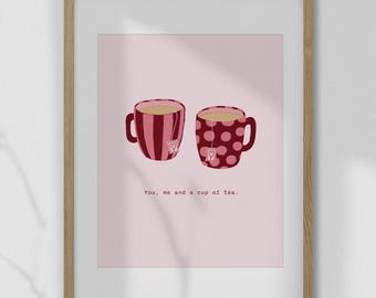 May include: A framed print featuring two mugs of tea. One mug is striped, the other has polka dots. Each mug has a heart-shaped tea bag tag. The text "You, me and a cup of tea" is below the mugs.