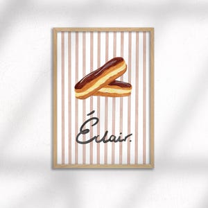 May include: A framed print showing two eclairs with chocolate and cream filling, set against a striped background of pink and white. The word "Éclair" is written in cursive below the pastries.