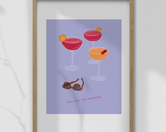 May include: A framed print featuring three cocktail glasses with red and orange drinks, garnished with fruit. Brown sunglasses are below the glasses. The text "chit-chat and cocktails" is at the bottom.