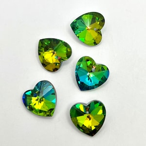 May include: Five heart-shaped crystal pendants with a hole at the top for stringing. The crystals have a gradient of colors, including yellow, green, and blue. The facets of the crystals reflect light, creating a sparkling effect. These pendants are suitable for jewelry making.