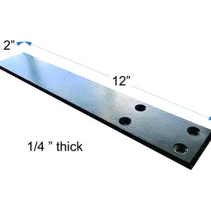 May include: Black metal flat bar with four holes, measuring 12 inches long by 2 inches wide and 1/4 inch thick.