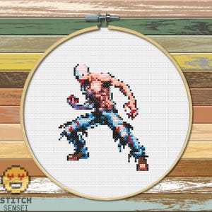 May include: Cross stitch pattern of a pixelated character from a video game. The character is a muscular, shirtless man with ripped jeans and a white mask. He is in a fighting pose with his arms raised.