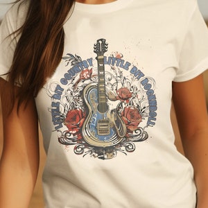 May include: White t-shirt with a graphic of a guitar and the text "Little Bit Country, Little Bit Rock and Roll".