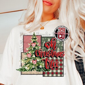 May include: White t-shirt featuring a Christmas tree design with the text "Oh Christmas Tree." The design includes a Christmas tree, red and white striped pattern, green tree pattern, and red and green plaid pattern.