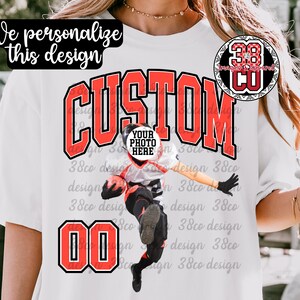 May include: White t-shirt with a custom design featuring the word "CUSTOM" in red block letters. The design includes a photo placeholder and the number "00" in red. The shirt also has the text "We personalize this design".