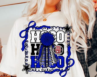 May include: A white t-shirt featuring a graphic design with the text HOCO in blue and black block letters. The design includes a blue homecoming mum, a blue ribbon border, two black stars, and a circular logo with the text 38 CO in red and white.