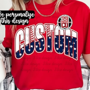 May include: A red t-shirt with the word "CUSTOM" in white, blue, and red, with a baseball-themed design. The shirt also features a circular emblem with the number "38" and the text "CU". The text "We personalize this design" is also present.