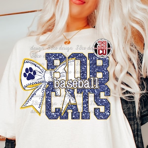 May include: White t-shirt with a navy blue and yellow design. The design features the words "BOBCATS Baseball CATS" in a glittery navy blue font, with a paw print bow. A circular logo is visible on the upper right.