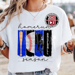 May include: White t-shirt with a baseball-themed graphic. The design includes a baseball bat, baseball, baseball uniform, and the words "homerun season". A circular logo with the number 38 is at the top.