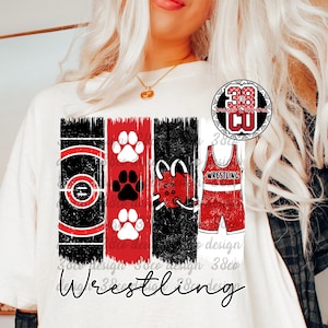 May include: White t-shirt with a distressed design featuring wrestling-themed graphics. The design includes a wrestling mat, paw prints, a headgear, and a singlet. The word "Wrestling" is written in a script font.