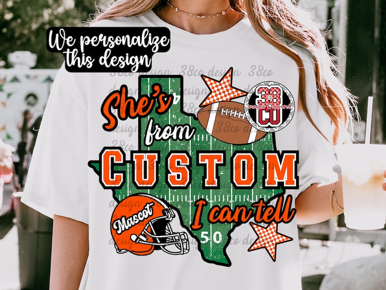May include: A white t-shirt featuring a graphic of the state of Texas in green with white yard lines. The design includes the text "She's from CUSTOM I can tell", an orange football helmet, a brown football, and two orange and white checkered stars.