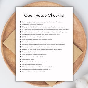 May include: A white Open House Checklist on a wooden tray with a beige envelope. The checklist includes items like setting the mood, setting AC temperature, and ensuring the property is secure.